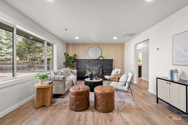 living room featuring baseboards, a fireplace, wood finished floors, and recessed lighting