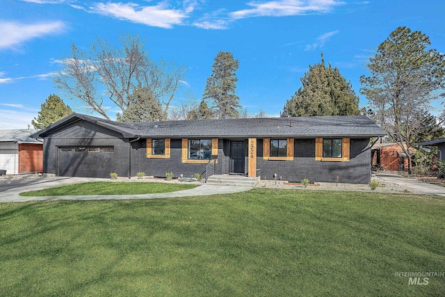 single story home featuring brick siding, a garage, a front lawn, and concrete driveway