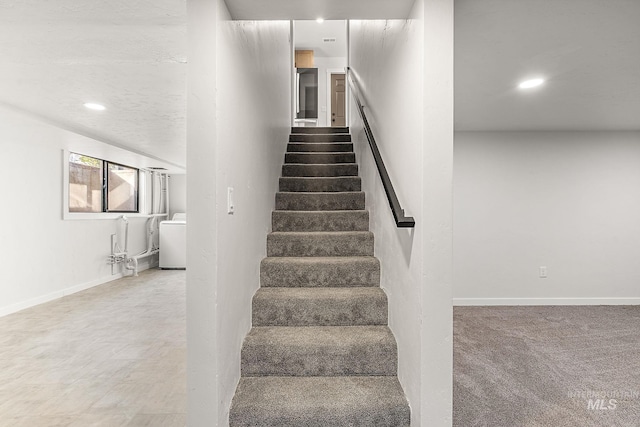 stairs with recessed lighting, washer / dryer, and baseboards