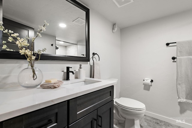 full bathroom featuring toilet, vanity, baseboards, and wood finished floors