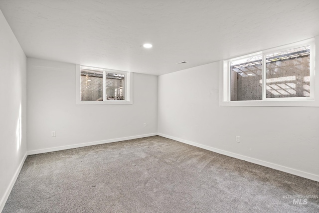 spare room with carpet flooring, baseboards, and recessed lighting