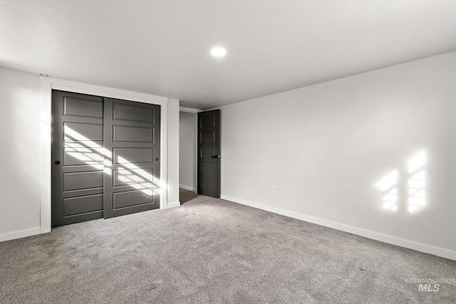 unfurnished bedroom featuring carpet flooring, baseboards, and recessed lighting