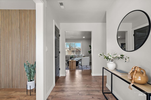 hall with wood finished floors and baseboards