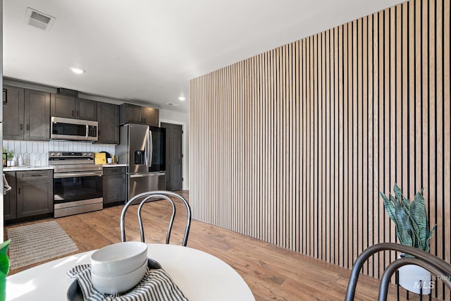 dining room with light wood-style floors and recessed lighting