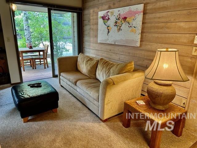 4139 Bluff Condo Dr, Sun Valley, ID 83353 - living room with wooden walls and light colored carpet