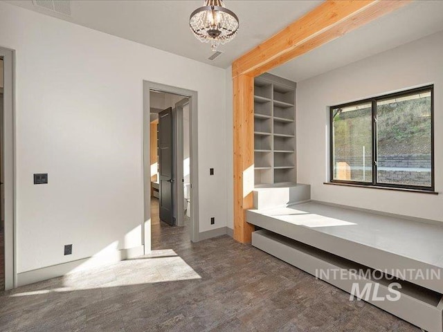 interior space with an inviting chandelier, beam ceiling, baseboards, and visible vents