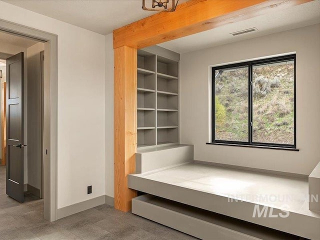 interior space featuring baseboards, visible vents, and built in features