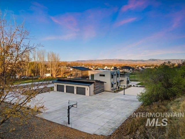 view of front of house featuring a garage and a mountain view