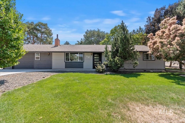 ranch-style house featuring a chimney, driveway, a garage, and a front lawn