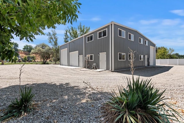exterior space with an outbuilding, fence, and a detached garage