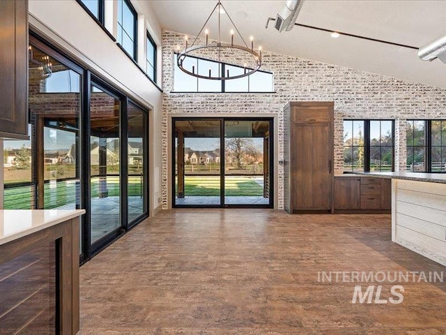 unfurnished sunroom featuring a chandelier