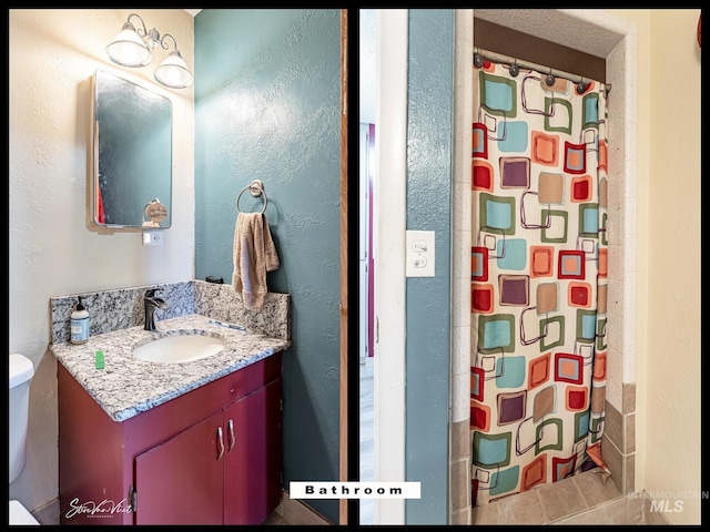 bathroom featuring vanity, toilet, and a shower with shower curtain