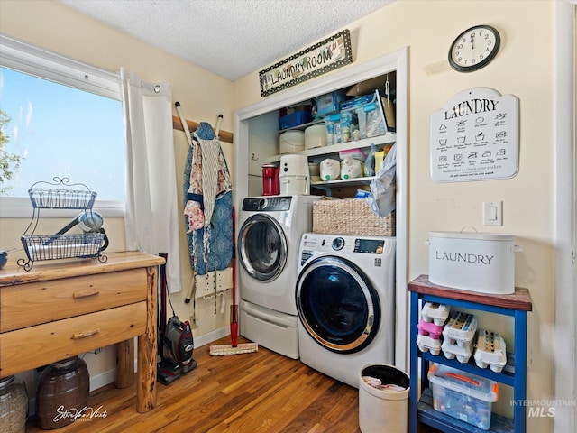 laundry area featuring washer and clothes dryer, dark hardwood / wood-style floors, and a textured ceiling