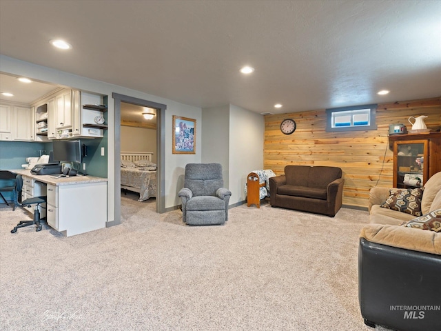 living room with light colored carpet and wooden walls