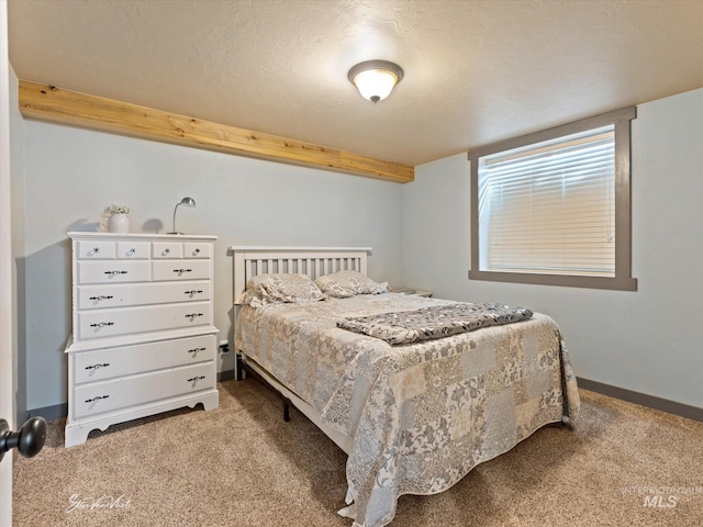 bedroom featuring a textured ceiling and carpet