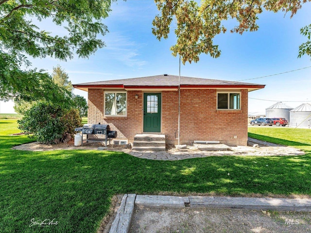 rear view of house with a lawn