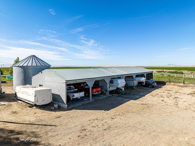 view of car parking featuring a rural view