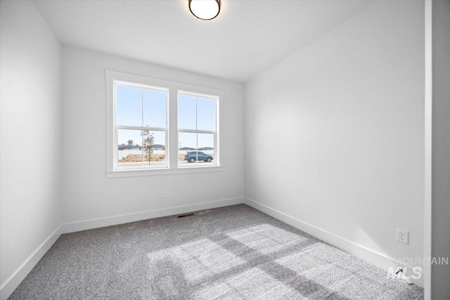carpeted spare room with baseboards