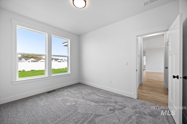unfurnished bedroom featuring baseboards and carpet flooring