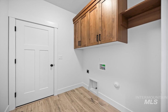 clothes washing area with cabinet space, hookup for an electric dryer, hookup for a washing machine, light wood finished floors, and baseboards