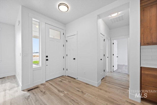 entrance foyer with light wood-style flooring and baseboards