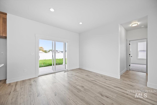 unfurnished room with light wood-style flooring, baseboards, and recessed lighting
