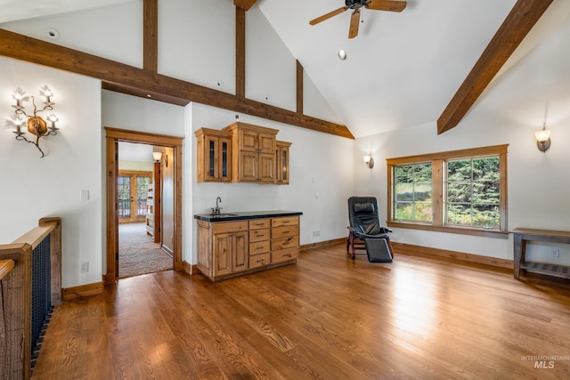 carpeted living room featuring sink, high vaulted ceiling, and ceiling fan