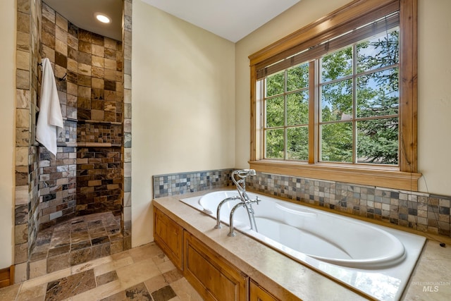 bathroom with plus walk in shower and tile patterned flooring