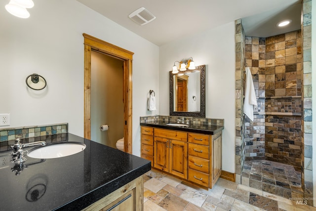 full bathroom with backsplash, toilet, vanity, independent shower and bath, and tile patterned floors