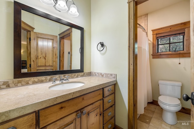 bathroom featuring vanity, tile patterned floors, and toilet