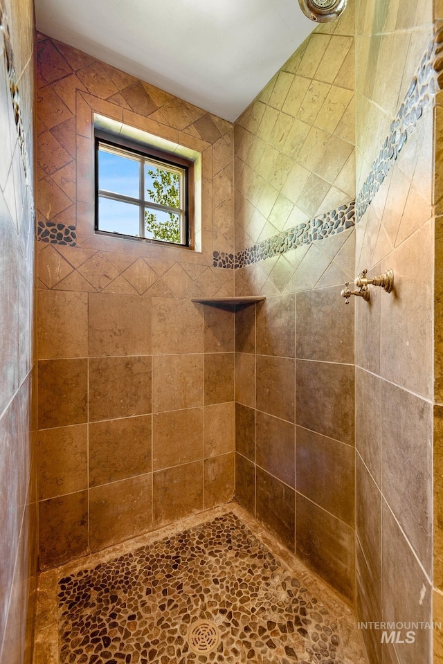 bathroom with a tile shower