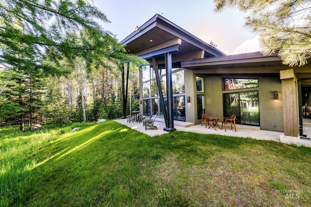1115 Heavens Gate Ct, Mccall, ID 83638 - back of property featuring stucco siding, a yard, and a patio area