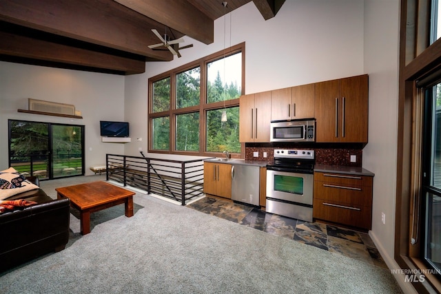 1115 Heavens Gate Ct, Mccall, ID 83638 - kitchen with appliances with stainless steel finishes, a high ceiling, backsplash, ceiling fan, and beam ceiling