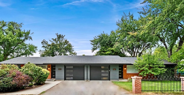 single story home with a front lawn and a garage