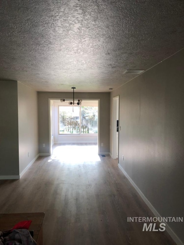 3109 N Tamarack Dr, Boise, ID 83703 - interior space with a textured ceiling, wood finished floors, and baseboards