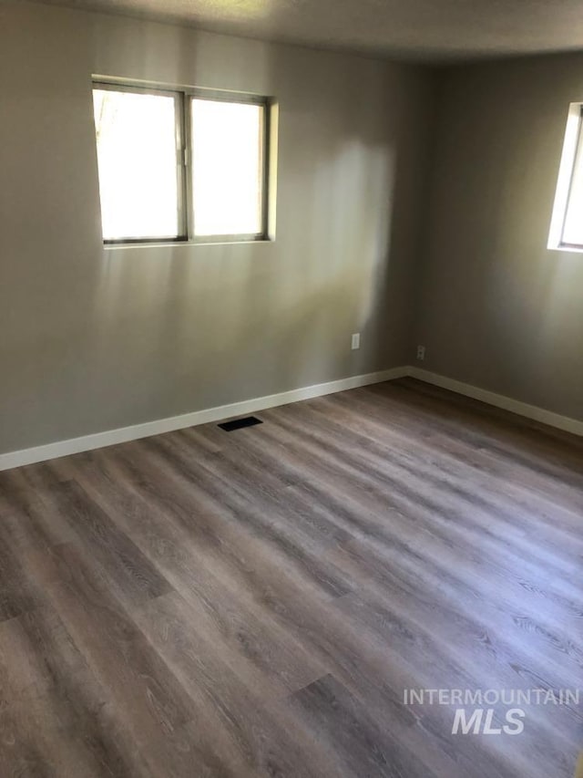 3109 N Tamarack Dr, Boise, ID 83703 - spare room featuring dark wood-type flooring, baseboards, and visible vents