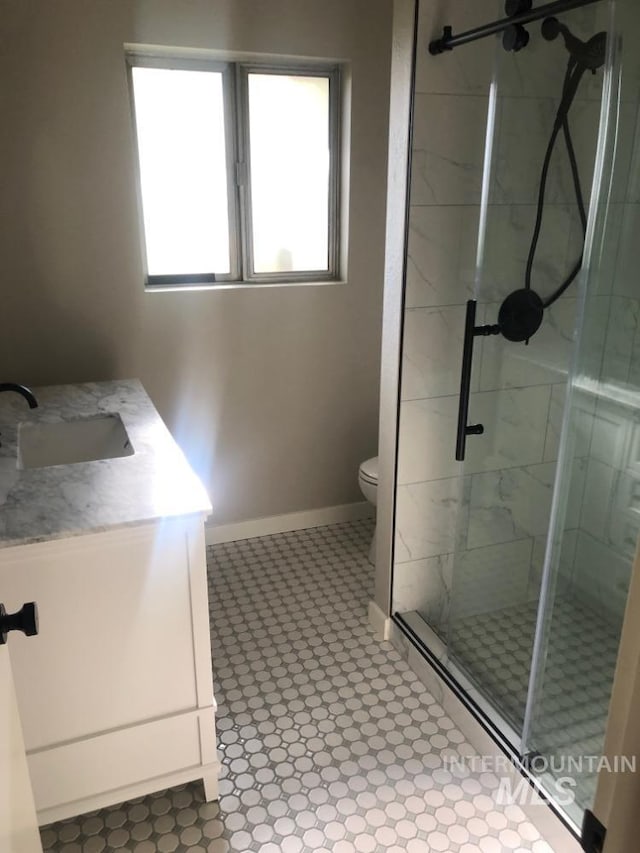 3109 N Tamarack Dr, Boise, ID 83703 - full bathroom featuring toilet, a stall shower, vanity, and baseboards