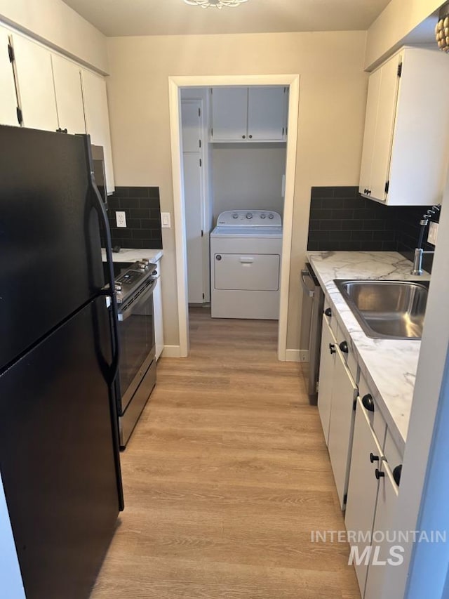 3109 N Tamarack Dr, Boise, ID 83703 - kitchen with stainless steel appliances, washer / dryer, light wood-type flooring, and a sink