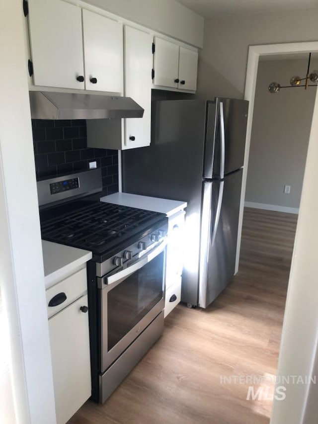 3109 N Tamarack Dr, Boise, ID 83703 - kitchen with light wood-style floors, stainless steel range with gas cooktop, white cabinetry, and under cabinet range hood