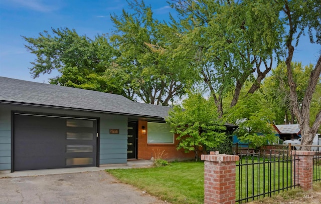 view of front of property featuring a front lawn and a garage