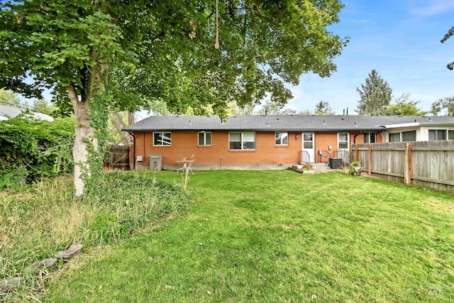 3109 N Tamarack Dr, Boise, ID 83703 - rear view of property with brick siding, fence, cooling unit, and a lawn