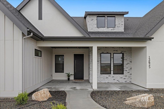 13625 Hickory Rnch, Nampa, ID 83651 - view of exterior entry with board and batten siding and roof with shingles