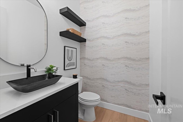 13625 Hickory Rnch, Nampa, ID 83651 - bathroom featuring wood finished floors, toilet, and vanity