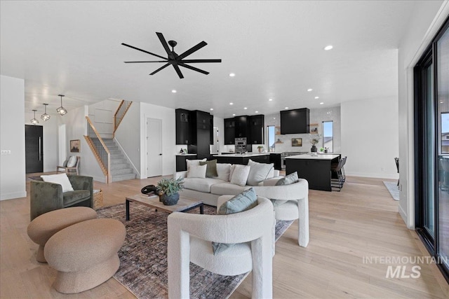 13625 Hickory Rnch, Nampa, ID 83651 - living area with stairs, light wood finished floors, baseboards, and recessed lighting