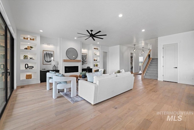13625 Hickory Rnch, Nampa, ID 83651 - living room featuring a fireplace, light wood-style floors, stairway, built in shelves, and recessed lighting