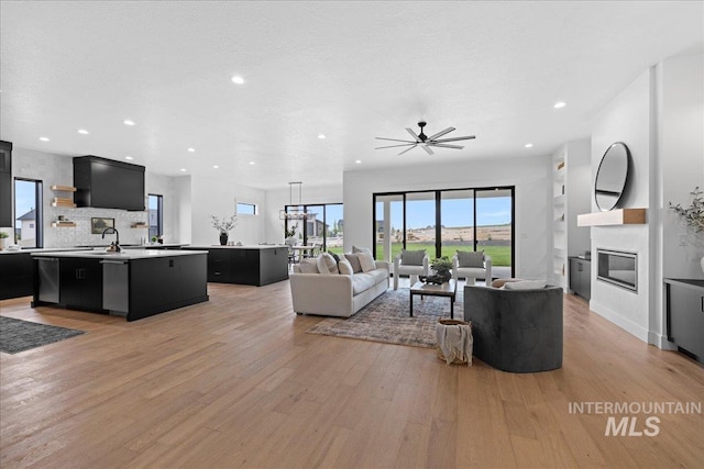 13625 Hickory Rnch, Nampa, ID 83651 - living room with light wood-style floors, a fireplace, recessed lighting, and a ceiling fan