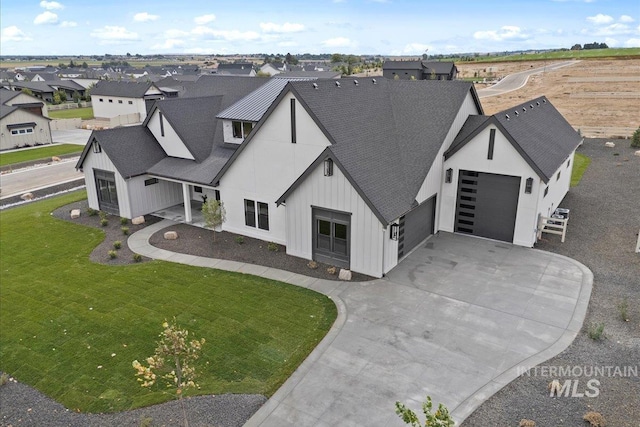 13625 Hickory Rnch, Nampa, ID 83651 - view of front facade featuring a shingled roof, driveway, a garage, and board and batten siding