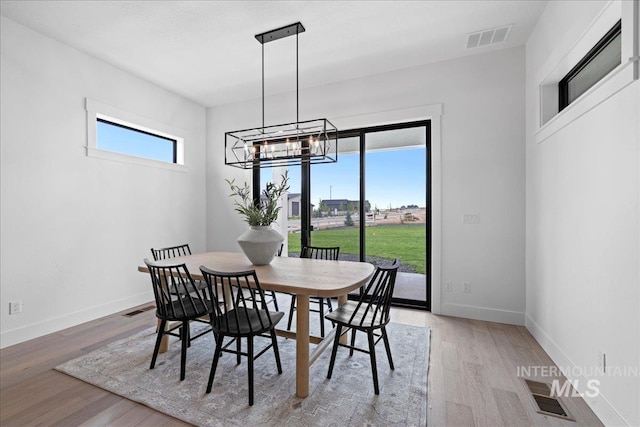 13625 Hickory Rnch, Nampa, ID 83651 - dining space with light wood finished floors, baseboards, and a chandelier