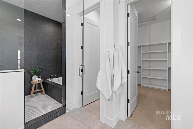 13625 Hickory Rnch, Nampa, ID 83651 - full bath featuring a textured ceiling, a shower with door, tile patterned flooring, a garden tub, and a walk in closet
