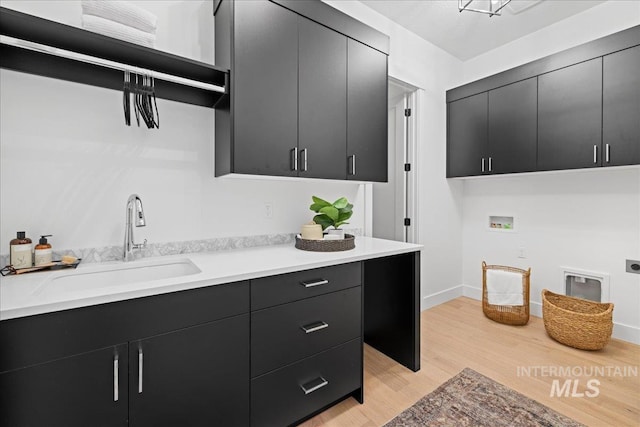 13625 Hickory Rnch, Nampa, ID 83651 - clothes washing area featuring cabinet space, hookup for an electric dryer, light wood-style flooring, hookup for a washing machine, and baseboards
